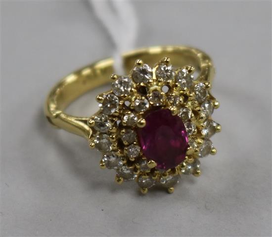 A yellow metal, ruby and diamond cluster ring, size K.